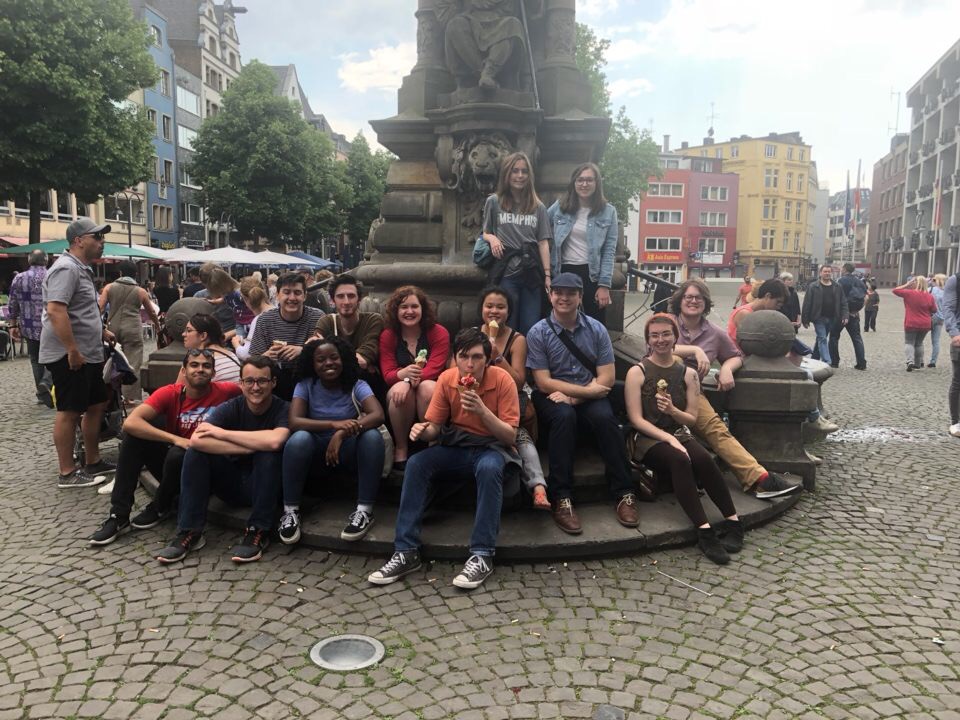 The class in front of a fountain the the old market of Cologne.