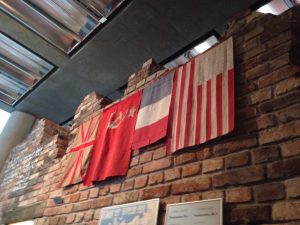 British, Soviet Union, French, and American flags made of repurposed Nazi flags and uniforms