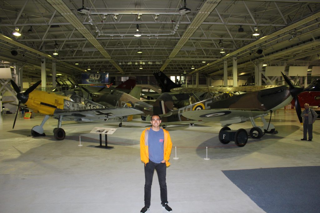 Raman standing in front of the battle of Britain aircraft
