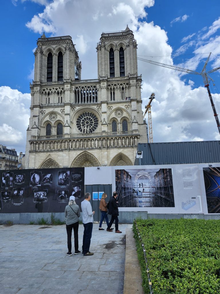 Notre-Dame-de-Paris cathedral in May 2024, behind a construction fence during restoration work after a 2019 fire.